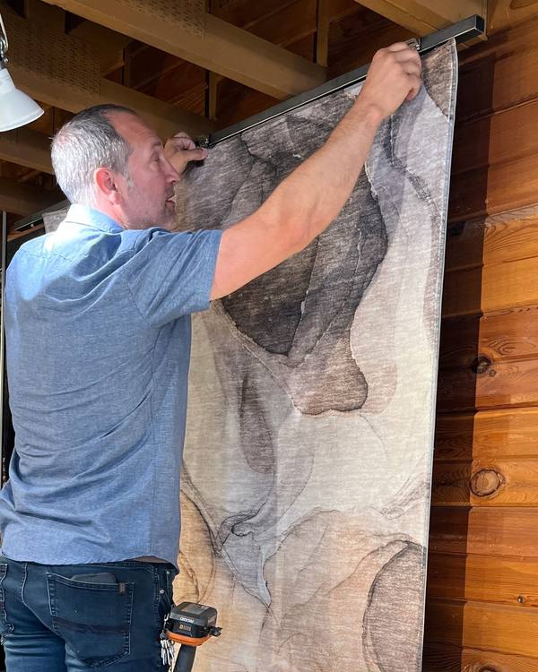 Hanging a new rug on the showroom rug rack