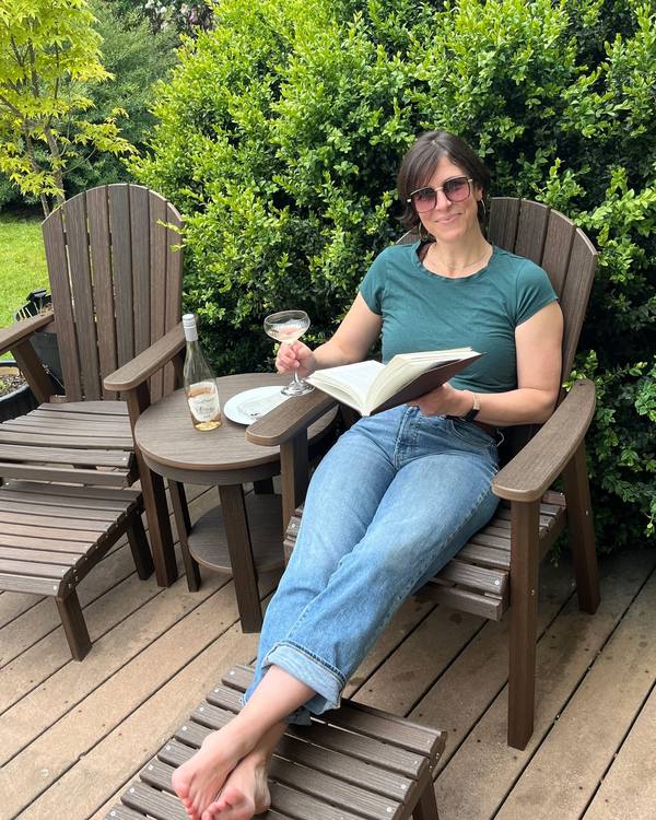 Relaxing with a book in Adirondack chairs on a garden deck